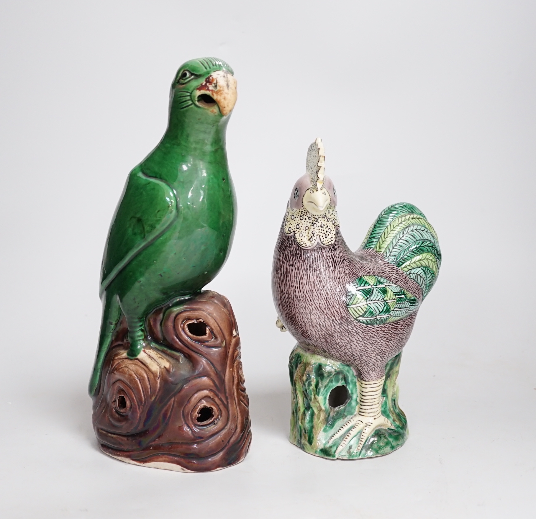 A Chinese green glazed model of a parrot, late 19th century and an early 20th century Chinese model of a cockerel, the largest 27cm high